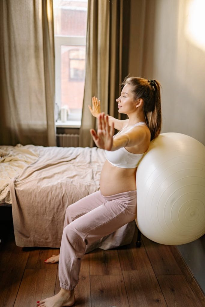 pexels photo 7155387 Expectant mother practicing yoga exercises indoors using an exercise ball.
